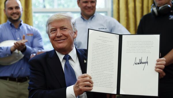 President Donald Trump holds up a National Manufacturing Day Proclamation after signing it in the Oval Office of the White House in Washington, Friday, Oct. 6, 2017 - Sputnik International