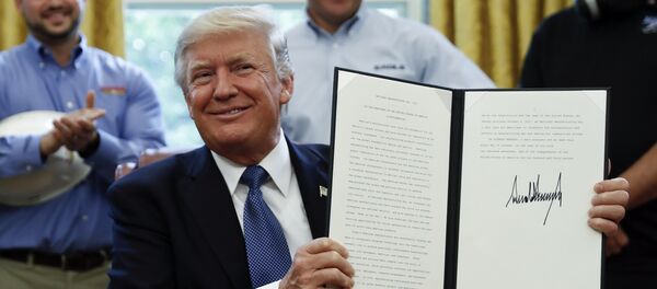 President Donald Trump holds up a National Manufacturing Day Proclamation after signing it in the Oval Office of the White House in Washington, Friday, Oct. 6, 2017 President Donald Trump holds up a National Manufacturing Day Proclamation after signing it in the Oval Office of the White House in Washington, Friday, Oct. 6, 2017 - Sputnik International