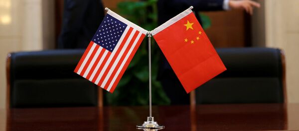 Chinese and U.S. flags are set up for a signing ceremony during a visit by U.S. Secretary of Transportation Elaine Chao at China's Ministry of Transport in Beijing, China April 27, 2018 - Sputnik International
