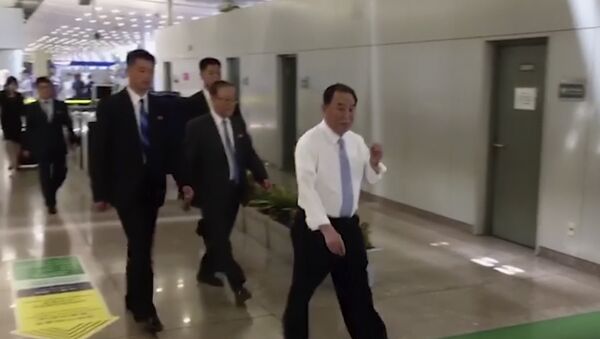 In this image made from video, Kim Yong Chol, in white, a former military intelligence chief who is now Kim Jong Un's top official on inter-Korean relations, walks upon arrival at Beijing airport in Beijing Tuesday, May 29, 2018 - Sputnik International
