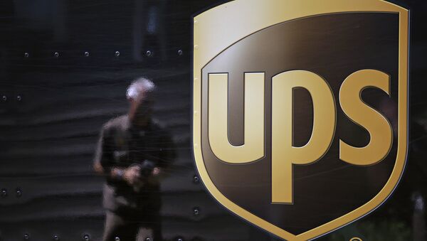 In this June 20, 2014, file photo, the United Parcel Service logo is seen on the side of a truck as driver Marty Thompson is reflected returning from a delivery in Cumming, Ga. - Sputnik International