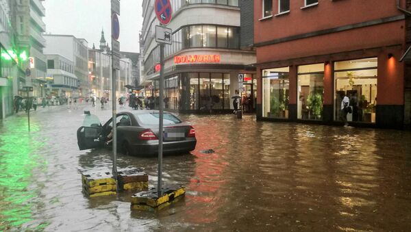 A car is stranded in the flood water following heavy rainfall in Wuppertal, western Germany on May 29, 2018 - Sputnik International