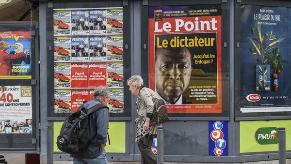 A man walks by a storefront displaying the front page of French news magazine Le Point showing a picture of Turkish president and reading the dictator, on 30 May, 2018 in Valence - Sputnik International