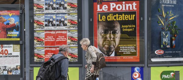 A man walks by a storefront displaying the front page of French news magazine Le Point showing a picture of Turkish president and reading the dictator, on 30 May, 2018 in Valence - Sputnik International