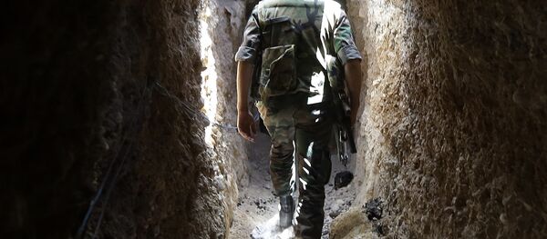 A Syrian army soldier makes his way in a tunnel reportedly previously used by rebel fighters in Jobar, a mostly rebel-held area on the eastern outskirts of Damascus on June 2, 2014 A Syrian army soldier makes his way in a tunnel reportedly previously used by rebel fighters in Jobar, a mostly rebel-held area on the eastern outskirts of Damascus on June 2, 2014 - Sputnik International