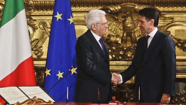 Italian President Sergio Mattarella, left, shakes hands with Premier Giuseppe Conte during the swearing-in ceremony for Italy's new government at Rome's Quirinale Presidential Palace, Friday, June 1, 2018 - Sputnik International