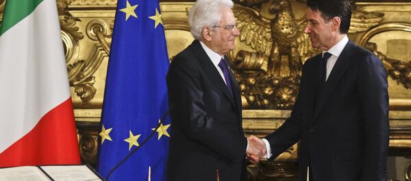 Italian President Sergio Mattarella, left, shakes hands with Premier Giuseppe Conte during the swearing-in ceremony for Italy's new government at Rome's Quirinale Presidential Palace, Friday, June 1, 2018 - Sputnik International