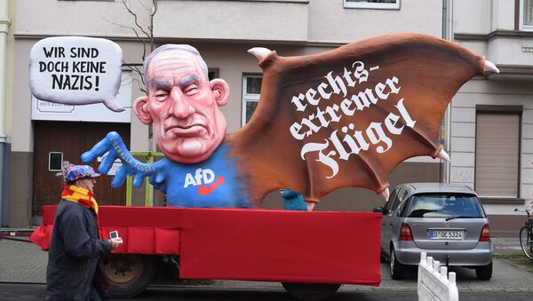 A carnival float, depicting co-leader of the parliamentary group of the Alternative for Germany (AfD) far-right party Alexander Gauland, is pictured during a carnival parade on Rose Monday on February 12, 2018 in Duesseldorf, western Germany. The writings read We are not nazis at all (L) and far-right wing(R) - Sputnik International