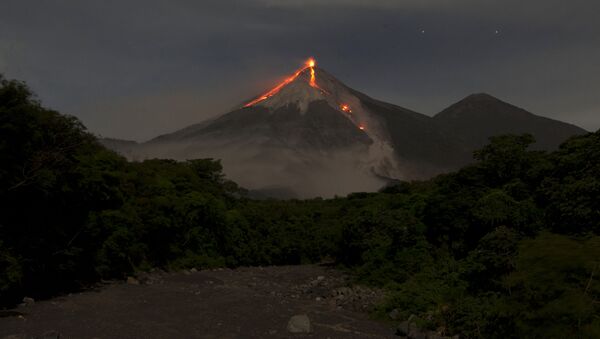 In this image taken with a long exposure, the Volcan de Fuego, or Volcano of Fire, spews hot molten lava from its crater in San Juan Alotenango, Guatemala, Wednesday, July 1, 2015 - Sputnik International