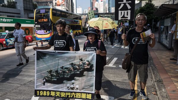 Protesters display a poster of the famous Tank Man standing in front of Chinese military tanks at Tiananmen Square in Beijing, during a rally in Hong Kong on May 28, 2017, ahead of the 28th anniversary of the June 4, 1989 Tiananmen Square crackdown - Sputnik International