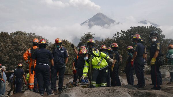 Firefighters carry the skeleton remains found buried at a house during a search at an area affected by the eruption of the Fuego volcano at El Rodeo in Escuintla - Sputnik International