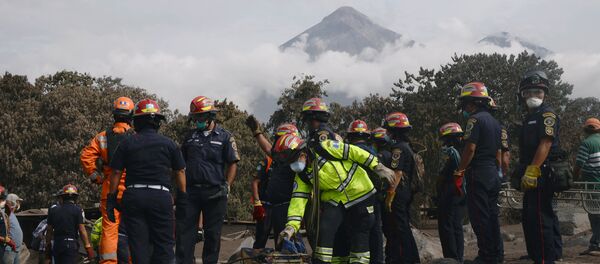 Firefighters carry the skeleton remains found buried at a house during a search at an area affected by the eruption of the Fuego volcano at El Rodeo in Escuintla - Sputnik International
