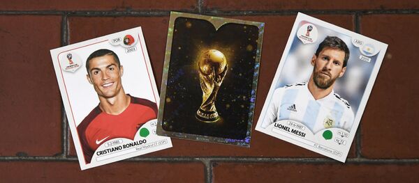 This photo taken on April 20, 2018 shows collectible cards featuring (L-R) Portugal's forward Cristiano Ronaldo, the Fifa World Cup Trophy and Argentina's forward Lionel Messi as part of a series featuring players for the 2018 Russia football World Cup at the Panini Group factory in Modena, northern Italy This photo taken on April 20, 2018 shows collectible cards featuring (L-R) Portugal's forward Cristiano Ronaldo, the Fifa World Cup Trophy and Argentina's forward Lionel Messi as part of a series featuring players for the 2018 Russia football World Cup at the Panini Group factory in Modena, northern Italy - Sputnik International