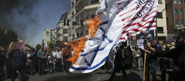 Iranian protesters burn a representation of the U.S. and Israeli flags in their annual anti-Israeli Al-Quds, Jerusalem, Day rally in Tehran, Iran, Friday, June 8, 2018 Iranian protesters burn a representation of the U.S. and Israeli flags in their annual anti-Israeli Al-Quds, Jerusalem, Day rally in Tehran, Iran, Friday, June 8, 2018 - Sputnik International