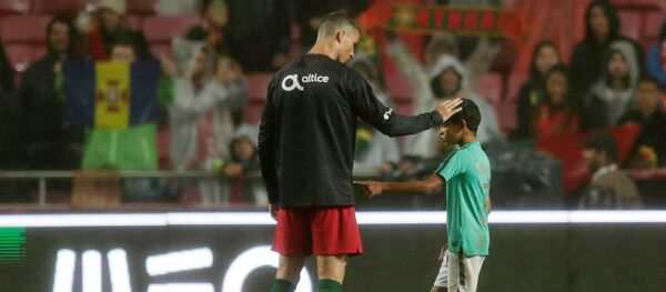 Soccer Football - International Friendly - Portugal vs Algeria - Estadio da Luz, Lisbon, Portugal - June 7, 2018 Portugal's Cristiano Ronaldo with his son after the match - Sputnik International