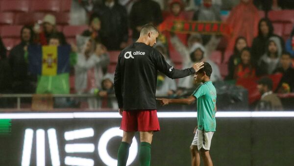 Soccer Football - International Friendly - Portugal vs Algeria - Estadio da Luz, Lisbon, Portugal - June 7, 2018 Portugal's Cristiano Ronaldo with his son after the match - Sputnik International