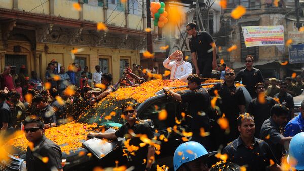 Indian Prime Minister Narendra Modi and leader of the Bharatiya Janata Party (BJP) gestures during a roadshow in support of state assembly election party candidates in Varanasi on March 4, 2017 - Sputnik International