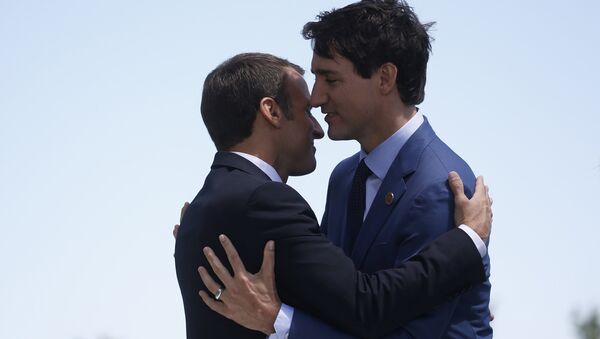 France's President Macron hugs Canada's Prime Minister Trudeau as he arrives at the G7 Summit in Charlevoix - Sputnik International