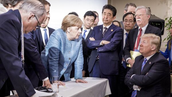 German Chancellor Angela Merkel, center, details policy to US President Donald Trump, seated at right, during the G7 Leaders Summit in La Malbaie, Quebec, Canada, on Saturday, June 9, 2018 - Sputnik International