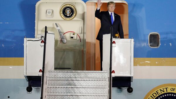 US President Donald Trump waves upon his arrival at Paya Lebar Air Base in Singapore, before his summit with North Korean leader Kim Jong Un, June 10, 2018. - Sputnik International