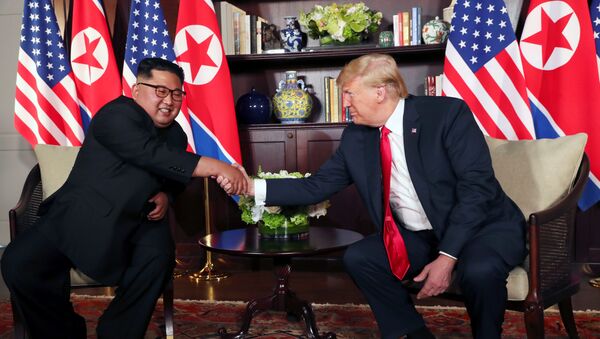 U.S. President Donald Trump shakes hands with North Korea's leader Kim Jong Un before their bilateral meeting at the Capella Hotel on Sentosa island in Singapore June 12, 2018. - Sputnik International