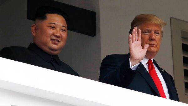 U.S. President Donald Trump and North Korean leader Kim Jong Un react at the Capella Hotel on Sentosa island in Singapore June 12, 2018. - Sputnik International