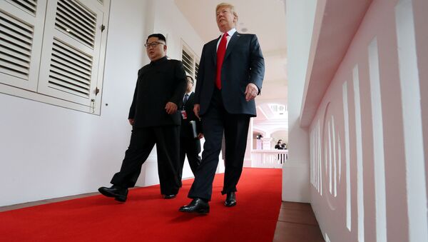 U.S. President Donald Trump walks with North Korean leader Kim Jong Un at the Capella Hotel on Sentosa island in Singapore June 12, 2018. - Sputnik International