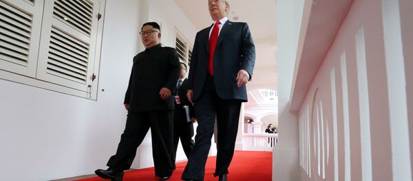 U.S. President Donald Trump walks with North Korean leader Kim Jong Un at the Capella Hotel on Sentosa island in Singapore June 12, 2018. - Sputnik International
