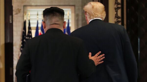 U.S. President Donald Trump and North Korea's leader Kim Jong Un leave after signing documents that acknowledge the progress of the talks and pledge to keep momentum going, after their summit at the Capella Hotel on Sentosa island in Singapore June 12, 2018 - Sputnik International