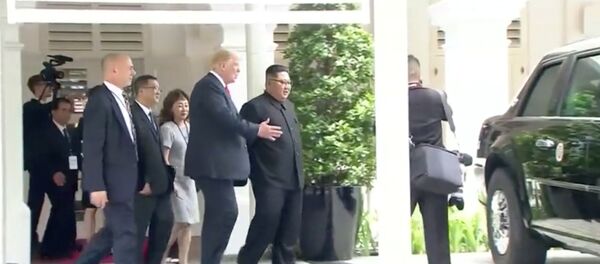 U.S. President Donald Trump shows North Korean leader Kim Jong Un his car, nicknamed The Beast, during their walk around Capella hotel after a working lunch at a summit in Singapore, June 12, 2018, in this still image taken from video - Sputnik International