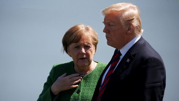 Germany's Chancellor Angela Merkel talks with U.S. President Donald Trump during a family photo at the G7 Summit in Charlevoix, Quebec, Canada, June 8, 2018 - Sputnik International