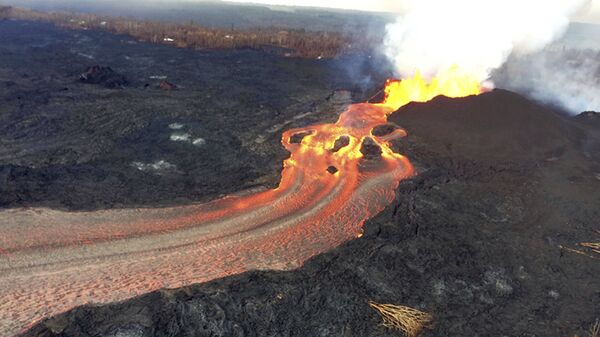 In this Sunday, June 10, 2018 photo from the U.S. Geological Survey, fissure 8 below Kilauea Volcano continues to erupt vigorously with lava streaming through a channel that reaches the ocean at Kapoho Bay on the island of Hawaii . The width of the active part of the lava channel varies along its length, but ranges from about 100 to 300 meters (yards) wide. A clear view of the cinder-and-spatter cone that's building around the vent from ongoing lava fountains can be seen here. - Sputnik International