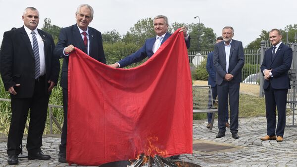Czech President Milos Zeman (2ndL) and Chancellor of the Office of the President Vratislav Mynar (C) burn a large piece of red textile, which refers to an oversized red underwear that was one of the symbols of political opponents, during its ritual burning on June 14, 2018 at the Prague Castle in the Czech capital - Sputnik International