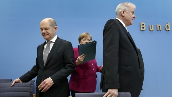 In this March 12, 2018 photo, from left, Olaf Scholz, acting chairman of the German Social Democratic Party (SPD), German Chancellor and chairwoman of the German Christian Democratic Union (CDU), Angela Merkel, and the chairman of the German Christian Social Union (CSU), Horst Seehofer, arrive for a joint press conference in Berlin, Germany - Sputnik International