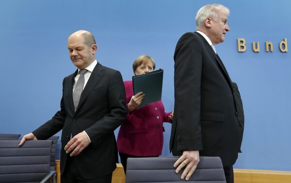 In this March 12, 2018 photo, from left, Olaf Scholz, acting chairman of the German Social Democratic Party (SPD), German Chancellor and chairwoman of the German Christian Democratic Union (CDU), Angela Merkel, and the chairman of the German Christian Social Union (CSU), Horst Seehofer, arrive for a joint press conference in Berlin, Germany In this March 12, 2018 photo, from left, Olaf Scholz, acting chairman of the German Social Democratic Party (SPD), German Chancellor and chairwoman of the German Christian Democratic Union (CDU), Angela Merkel, and the chairman of the German Christian Social Union (CSU), Horst Seehofer, arrive for a joint press conference in Berlin, Germany - Sputnik International