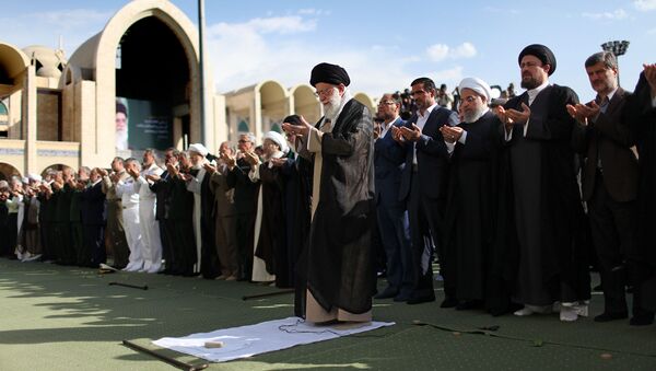 A handout picture released by the official website of the Iranian supreme leader shows Ayatollah Ali Khamenei (L) leading the Eid al-Fitr prayers at the Imam Khomeini grand mosque in the capital Tehran on June 15, 2018 - Sputnik International