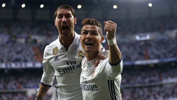 Real Madrid's Cristiano Ronaldo celebrates with Real Madrid's Sergio Ramos after scoring the opening goal during the Champions League semifinals first leg soccer match between Real Madrid and Atletico Madrid at Santiago Bernabeu stadium in Madrid, Spain, Tuesday May 2, 2017 - Sputnik International