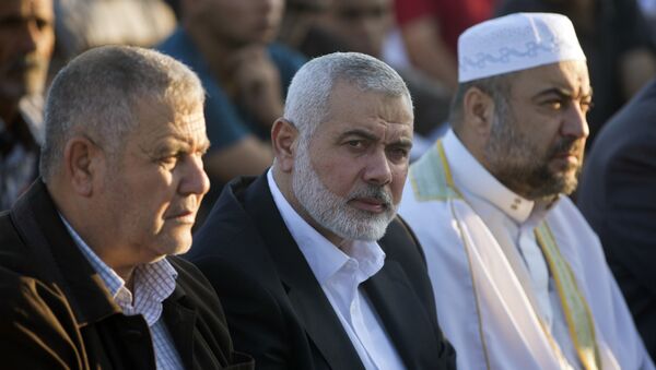 Palestinian Hamas top leader Ismail Haniyeh, center, attends the Eid al-Fitr prayers marking the end of the holy fasting month of Ramadan, in Eastern Gaza City, Friday, June 15, 2018 - Sputnik International