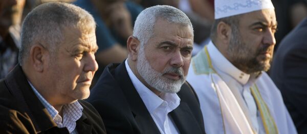 Palestinian Hamas top leader Ismail Haniyeh, center, attends the Eid al-Fitr prayers marking the end of the holy fasting month of Ramadan, in Eastern Gaza City, Friday, June 15, 2018 - Sputnik International