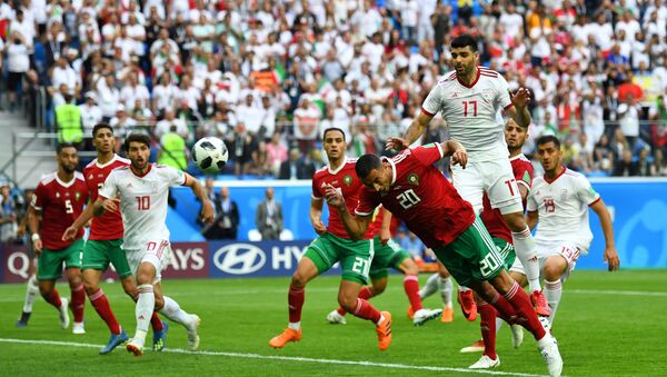Soccer Football - World Cup - Group B - Morocco vs Iran - Saint Petersburg Stadium, Saint Petersburg, Russia - June 15, 2018 Morocco's Aziz Bouhaddouz scores an own goal for Iran's first goal - Sputnik International