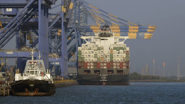 This photo taken on December 21, 2016 shows a container ship (R) docked at India's Adani Port Special Economic Zone (APSEZ) in Mundra - Sputnik International