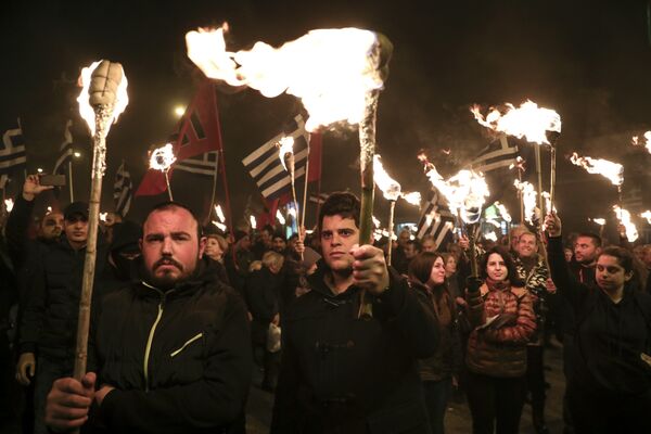 Supporters of Greece's extreme right Golden Dawn party raise torches during a rally commemorating a 1996 military incident which cost the lives of three Greek navy officers and brought Greece and Turkey to the brink of war, in Athens, on Saturday, Feb. 3, 2018 Supporters of Greece's extreme right Golden Dawn party raise torches during a rally commemorating a 1996 military incident which cost the lives of three Greek navy officers and brought Greece and Turkey to the brink of war, in Athens, on Saturday, Feb. 3, 2018 - Sputnik International