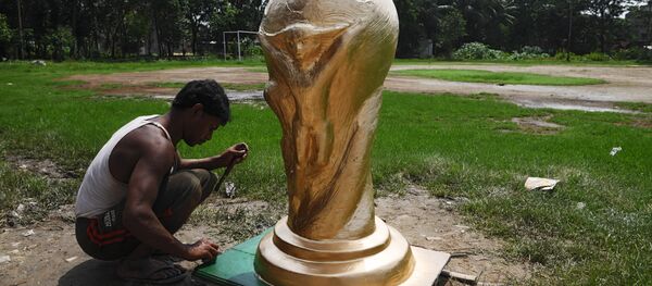 An Indian artisan works on clay model of the FIFA world cup trophy ordered by football fan clubs for decoration, ahead of the upcoming FIFA Russia 2018 World Cup, in Kolkata on June 13, 2018 An Indian artisan works on clay model of the FIFA world cup trophy ordered by football fan clubs for decoration, ahead of the upcoming FIFA Russia 2018 World Cup, in Kolkata on June 13, 2018 - Sputnik International
