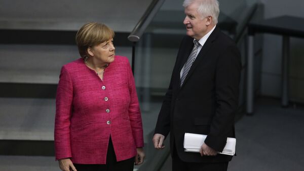 German Chancellor Angela Merkel, left, talks with German Interior Minister Horst Seehofer, right, during the first day of the budget 2018 debate at the parliament Bundestag at the Reichstag building in Berlin, Tuesday, May 15, 2018 - Sputnik International