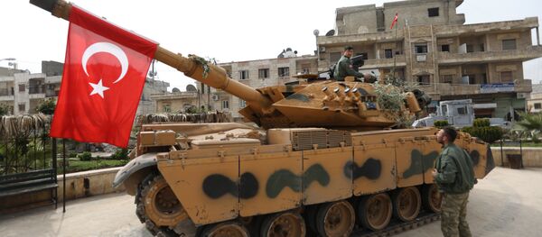 A tank belonging to Turkish soldiers and Ankara-backed Syrian Arab fighters is seen in the Kurdish-majority city of Afrin in northwestern Syria after they took control of it from Kurdish People's Protection Units (YPG) on March 18, 2018 - Sputnik International