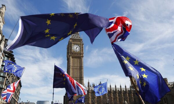 EU and Union flags fly above Parliament Square during a Unite for Europe march, in central London, Britain  - Sputnik International