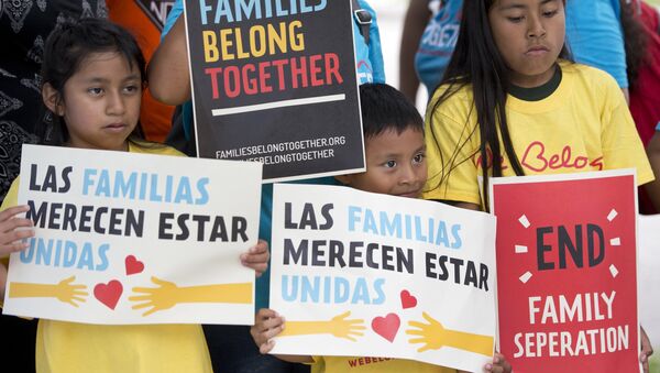 In this June 1, 2018, file photo, children hold signs during a demonstration in front of the Immigration and Customs Enforcement offices in Miramar, Fla. The Trump administration's move to separate immigrant parents from their children on the U.S.-Mexico border has turned into a full-blown crisis in recent weeks - Sputnik International