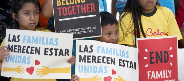 In this June 1, 2018, file photo, children hold signs during a demonstration in front of the Immigration and Customs Enforcement offices in Miramar, Fla. The Trump administration's move to separate immigrant parents from their children on the U.S.-Mexico border has turned into a full-blown crisis in recent weeks - Sputnik International
