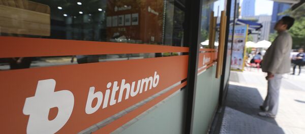A man watches the prices of bitcoin at Bithumb cryptocurrency exchange in Seoul, South Korea, Wednesday, June 20, 2018 - Sputnik International