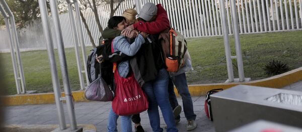 Cuban migrants embrace after traveling en route from Costa Rica to El Salvador, Guatemala and Mexico, before continuing their journey to U.S., on the border between the U.S. and Mexico in Reynosa, in Tamaulipas state, Mexico - Sputnik International